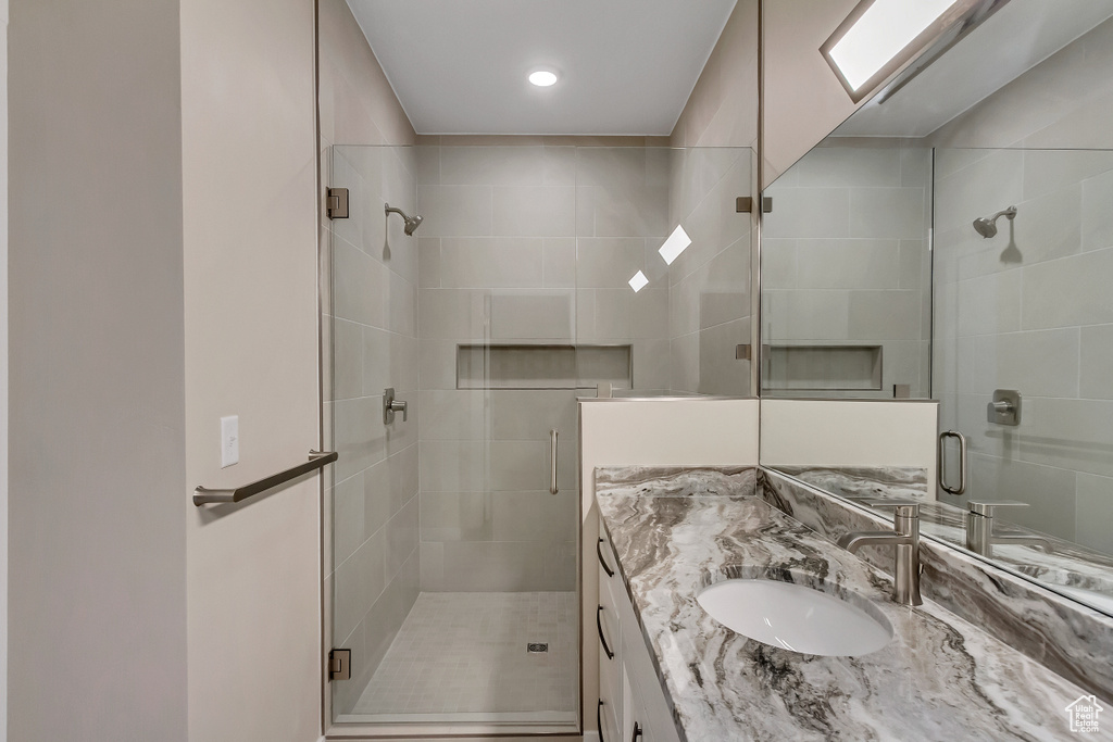 Bathroom with large vanity and walk in shower