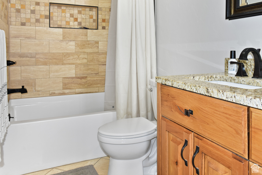 Full bathroom featuring shower / bathtub combination with curtain, large vanity, toilet, and tile floors
