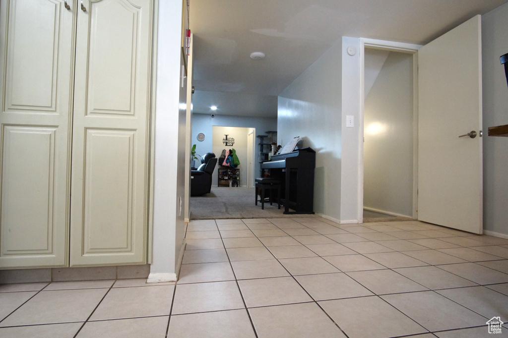 Hallway featuring light tile flooring