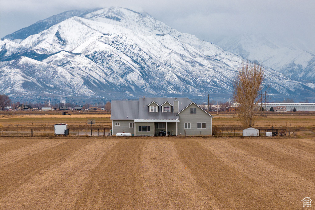 View of front of home featuring a storage shed and a mountain view