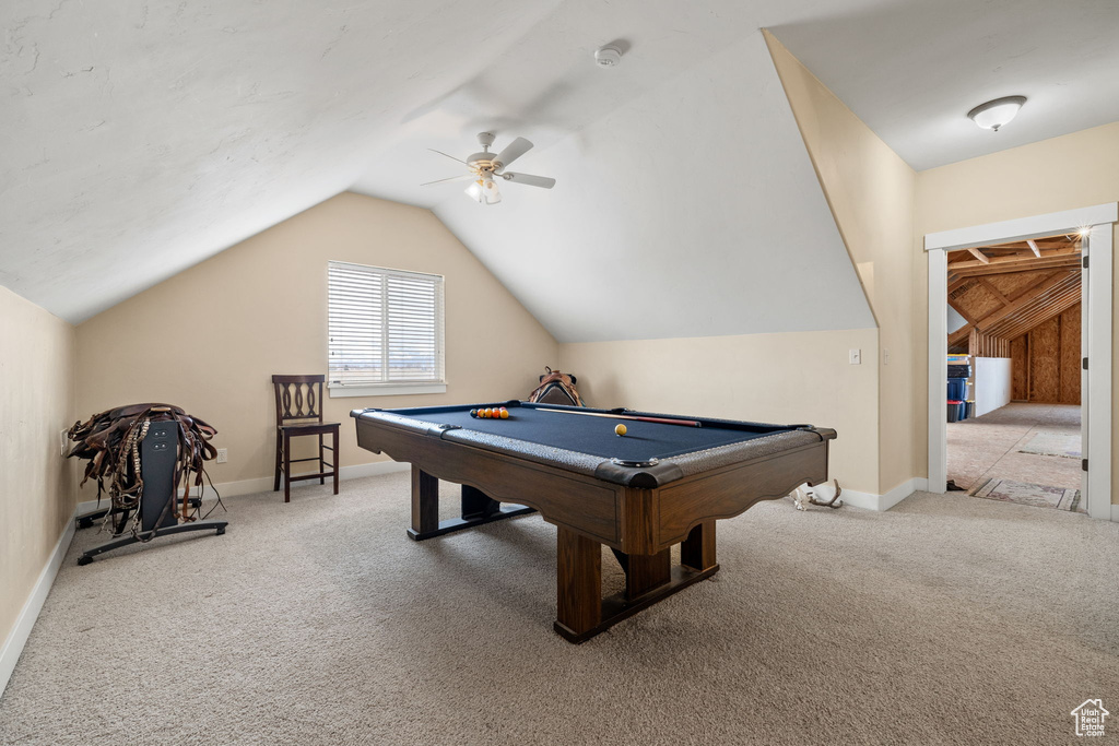 Recreation room with lofted ceiling, ceiling fan, light colored carpet, and billiards