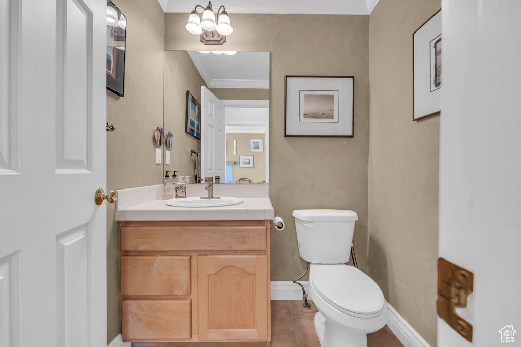 Bathroom with vanity, a chandelier, tile floors, and toilet