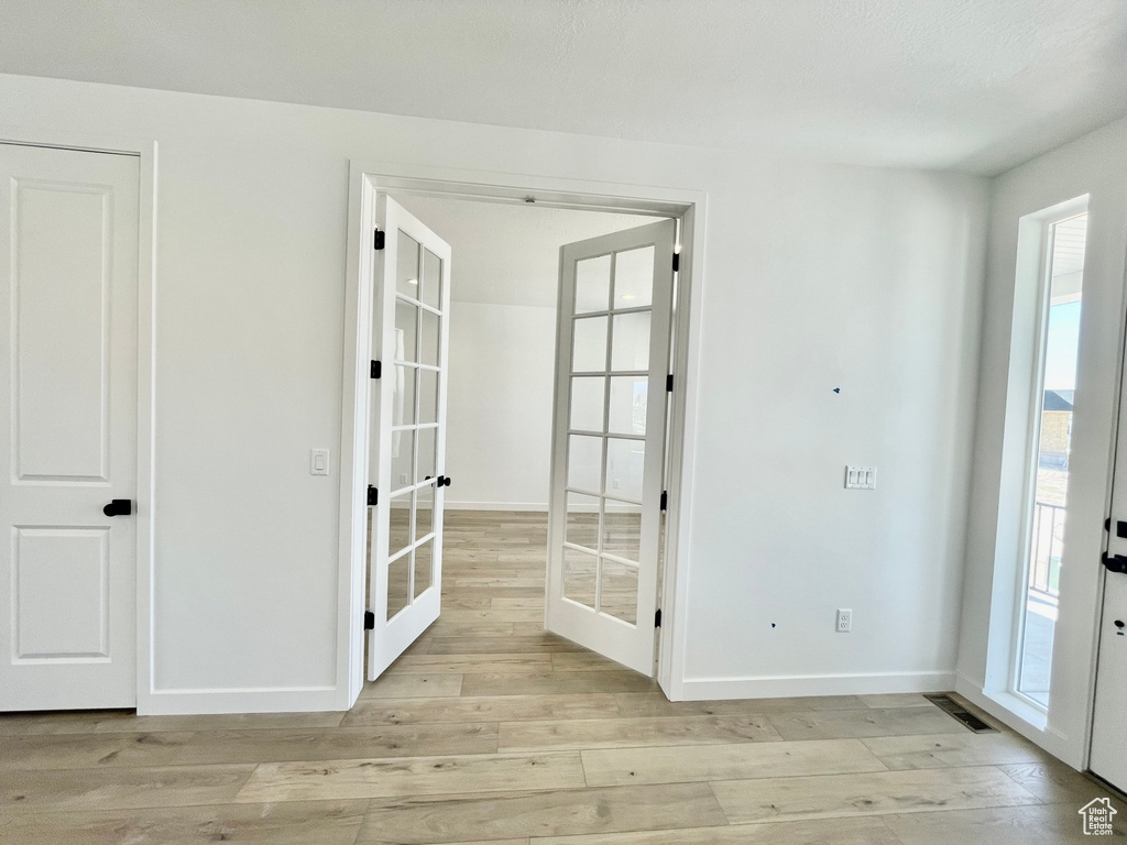 Doorway to outside featuring light hardwood / wood-style flooring and french doors