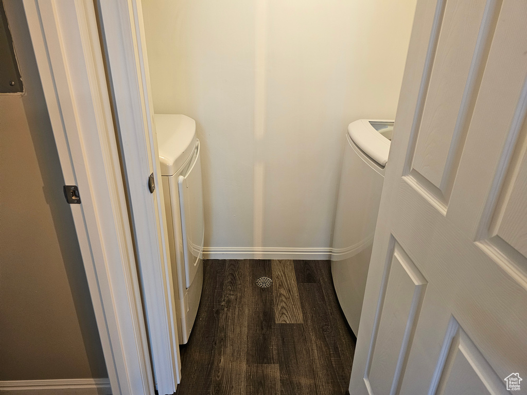 Bathroom featuring hardwood / wood-style flooring, toilet, and washer and dryer