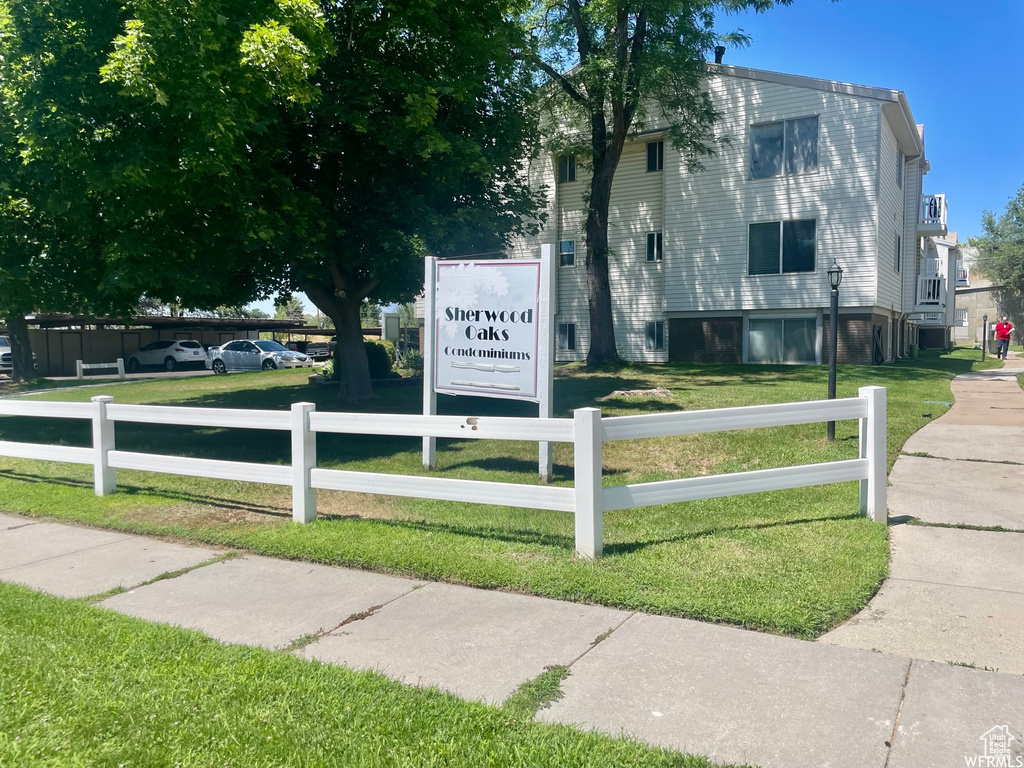 Community / neighborhood sign featuring a yard