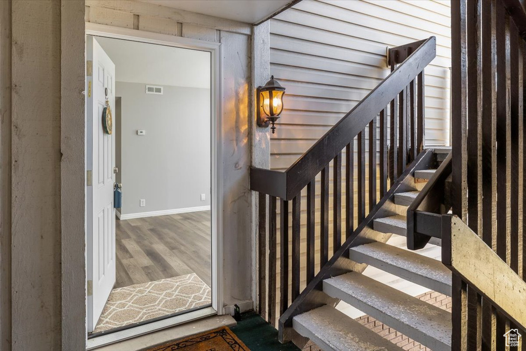 Stairs featuring dark hardwood / wood-style floors