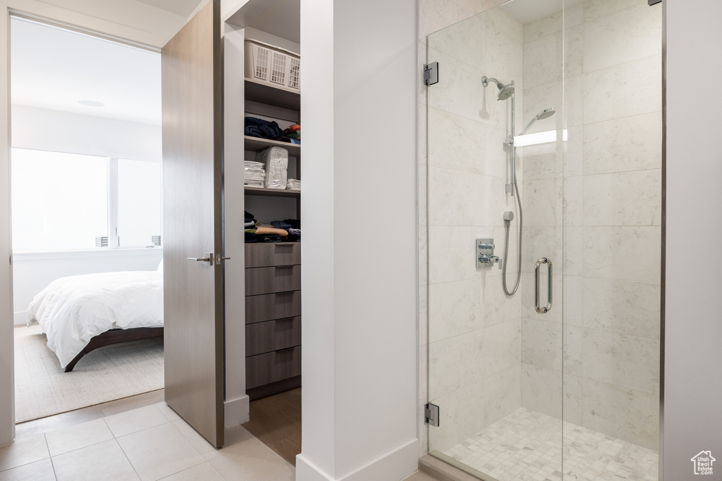 Bathroom with an enclosed shower and tile floors