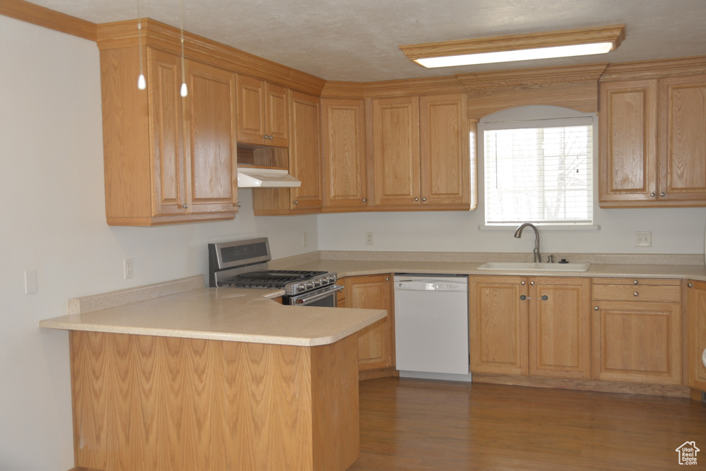 Kitchen with gas range, hardwood / wood-style floors, sink, white dishwasher, and kitchen peninsula