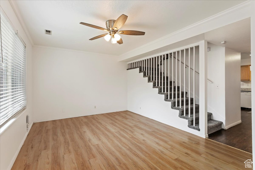Unfurnished room featuring crown molding, ceiling fan, and hardwood / wood-style floors