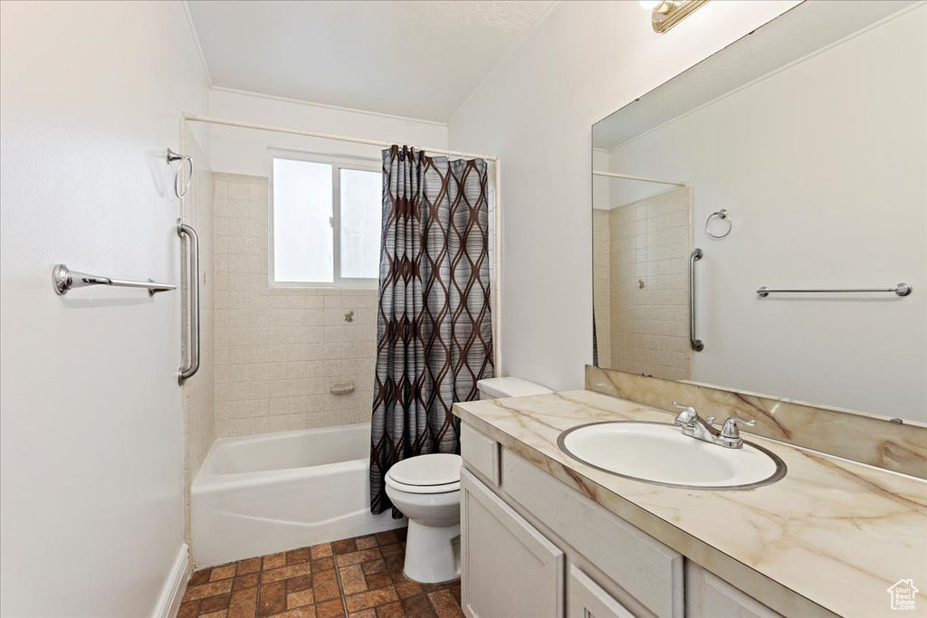Full bathroom featuring shower / bath combo, vanity, tile flooring, and toilet