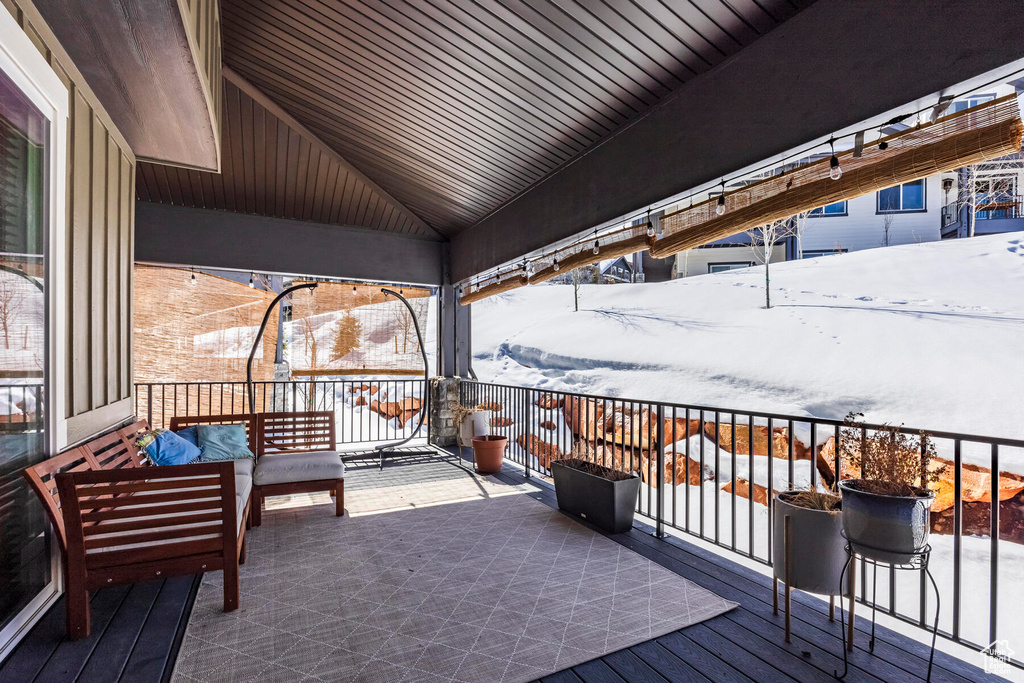 Snow covered deck featuring an outdoor hangout area