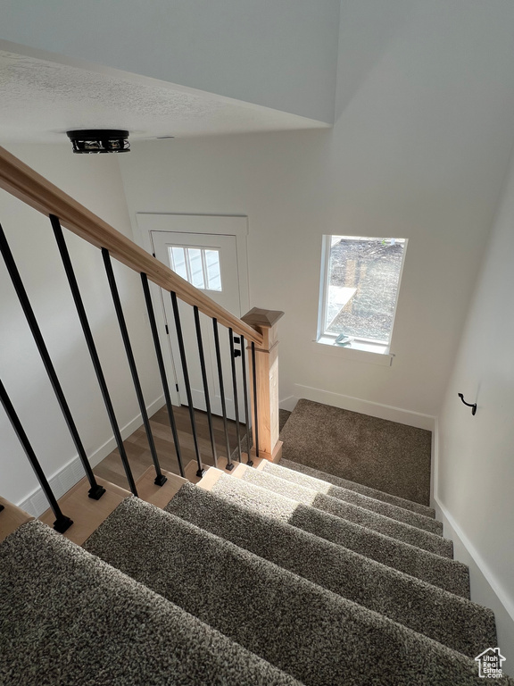 Stairway featuring hardwood / wood-style floors
