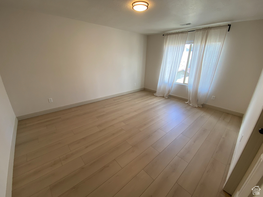 Unfurnished room with light wood-type flooring