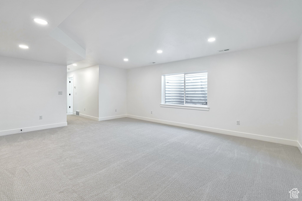 Unfurnished room with light carpet