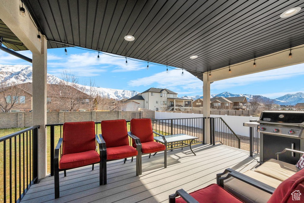 Deck with a mountain view and grilling area