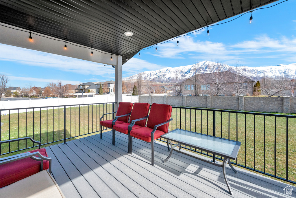 Wooden deck with a lawn and a mountain view