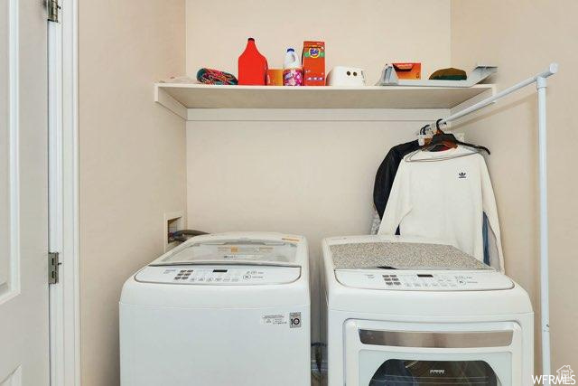Clothes washing area featuring independent washer and dryer and hookup for a washing machine