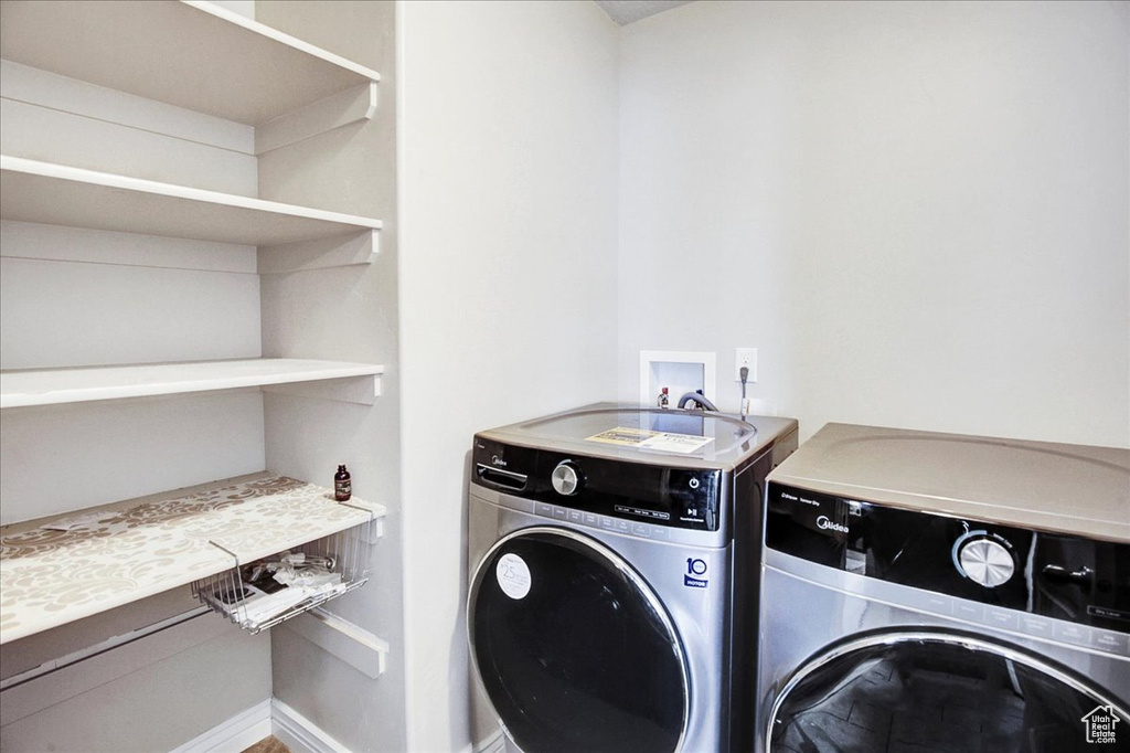 Laundry room featuring hookup for a washing machine and washer and clothes dryer