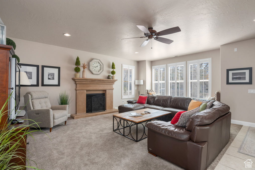 Living room with ceiling fan and light tile floors