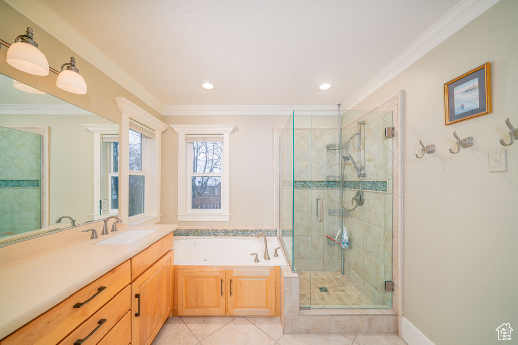 Bathroom featuring oversized vanity, plus walk in shower, tile floors, and ornamental molding