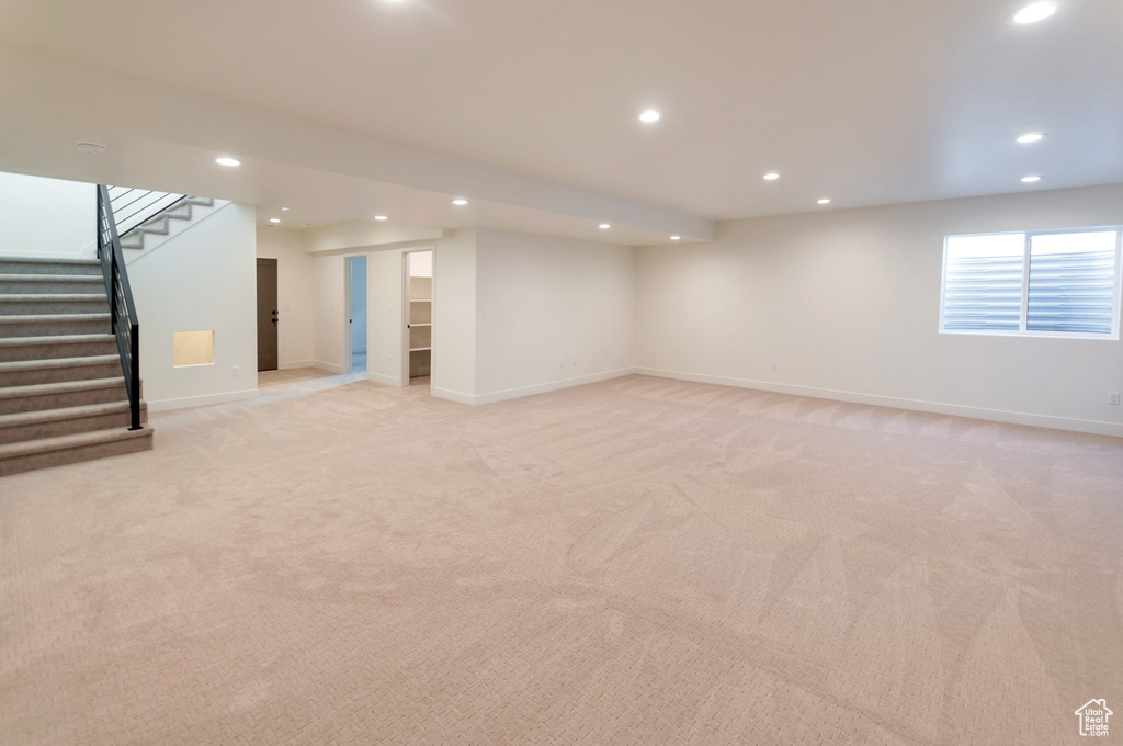 Basement with light colored carpet