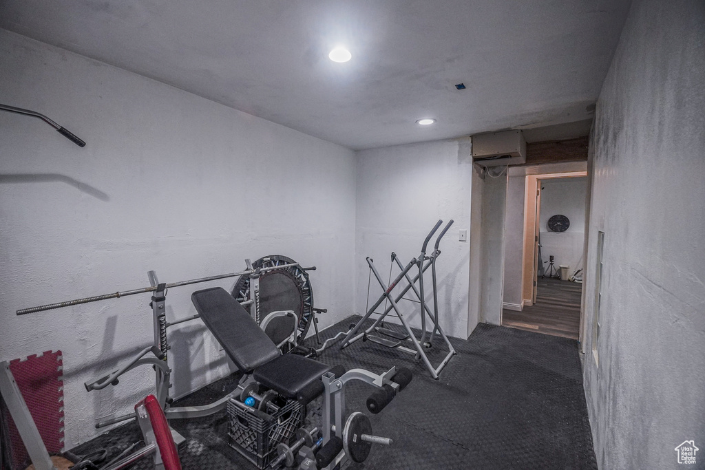 Workout area with dark hardwood / wood-style floors