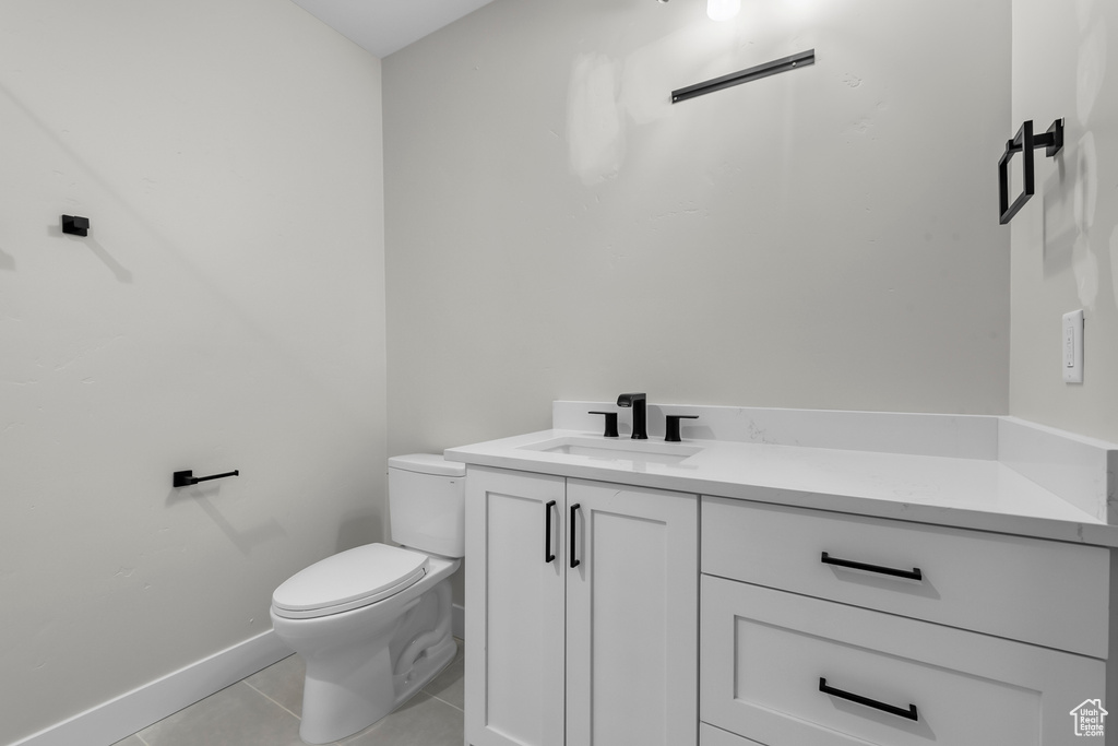 Bathroom with tile floors, toilet, and vanity