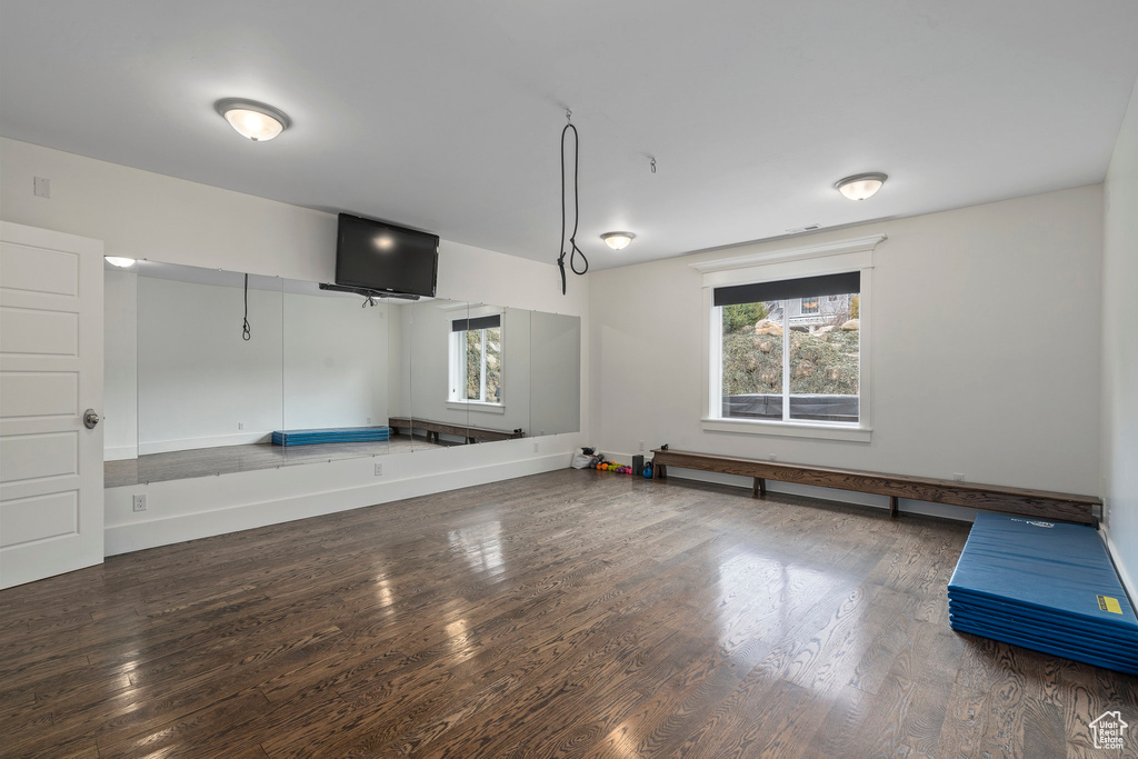 Interior space featuring dark wood-type flooring and a healthy amount of sunlight