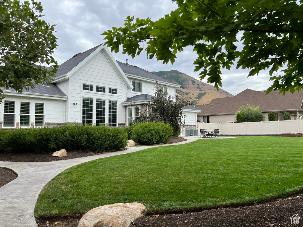 Rear view of property with a lawn