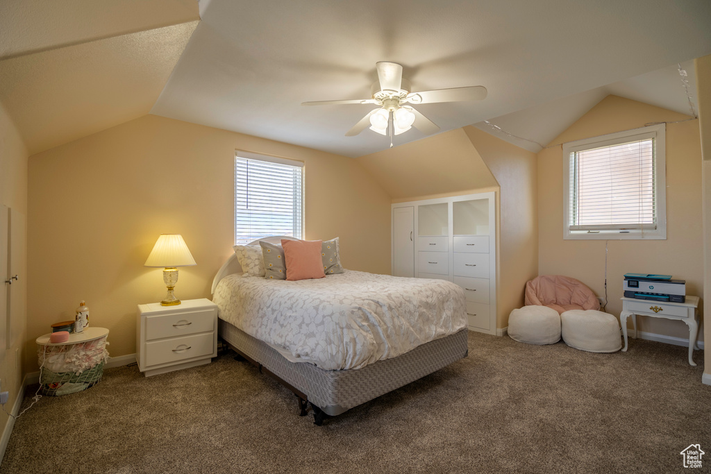 Carpeted bedroom featuring lofted ceiling, ceiling fan, and a closet