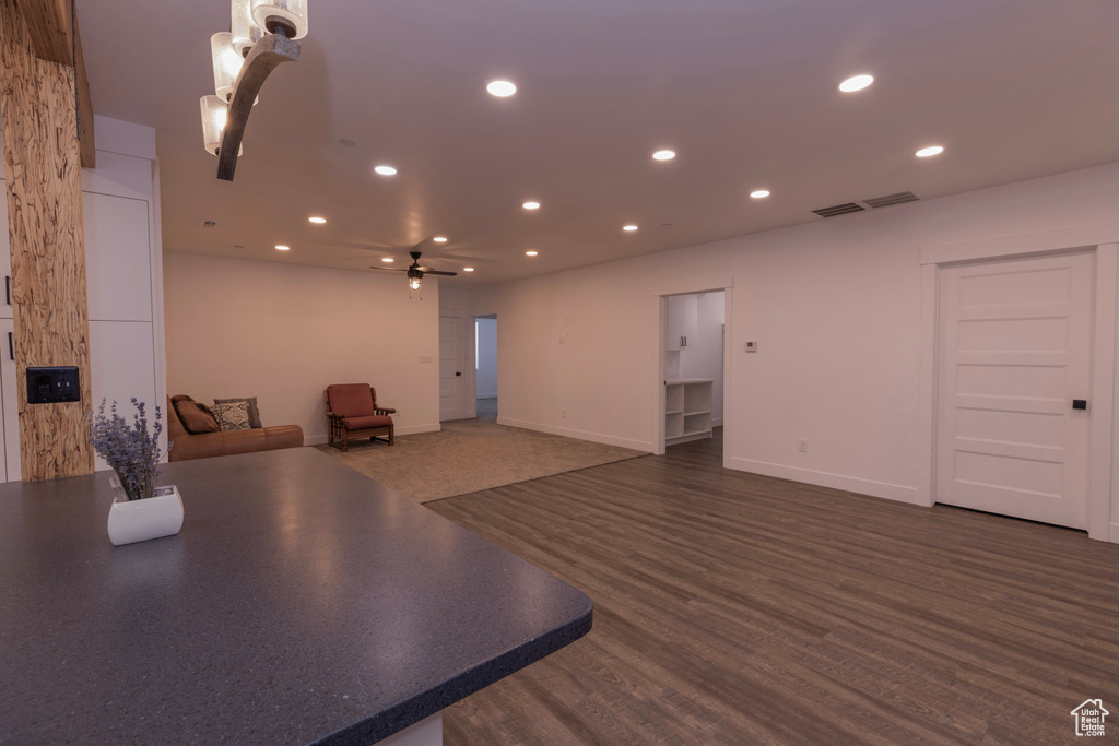 Interior space featuring dark wood-type flooring and ceiling fan