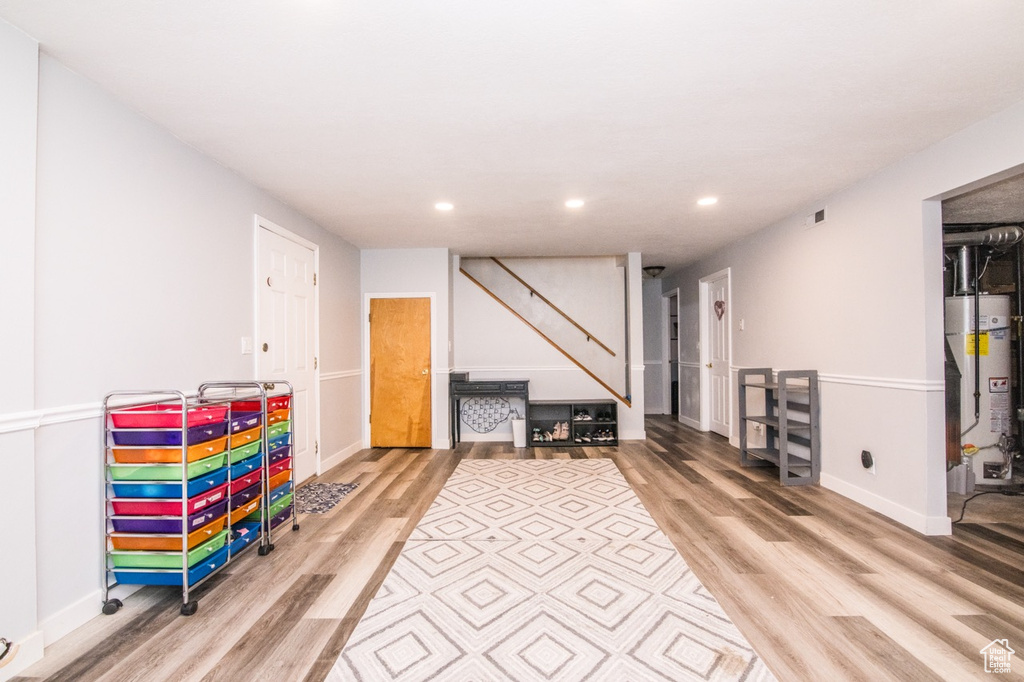 Rec room featuring gas water heater and light hardwood / wood-style flooring