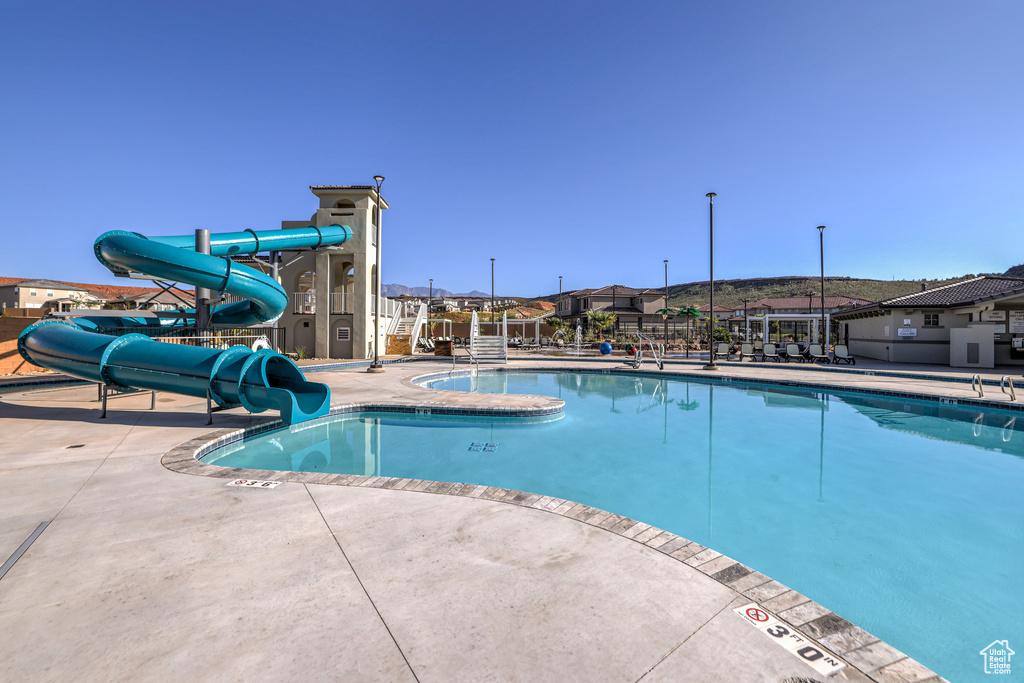 View of pool with a patio and a water slide