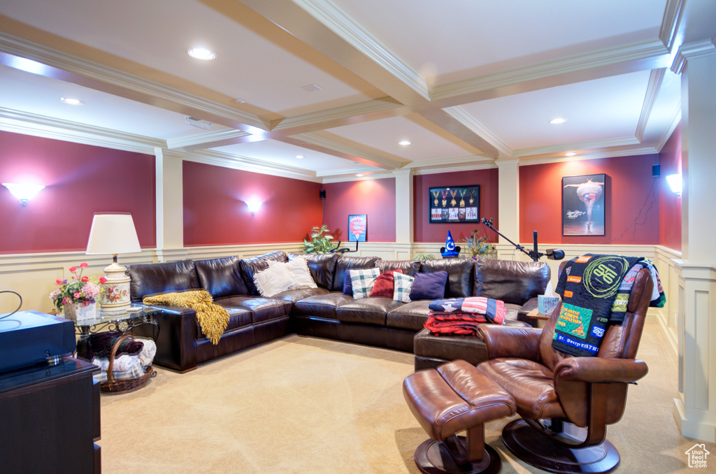 Carpeted home theater with coffered ceiling, ornamental molding, and beamed ceiling