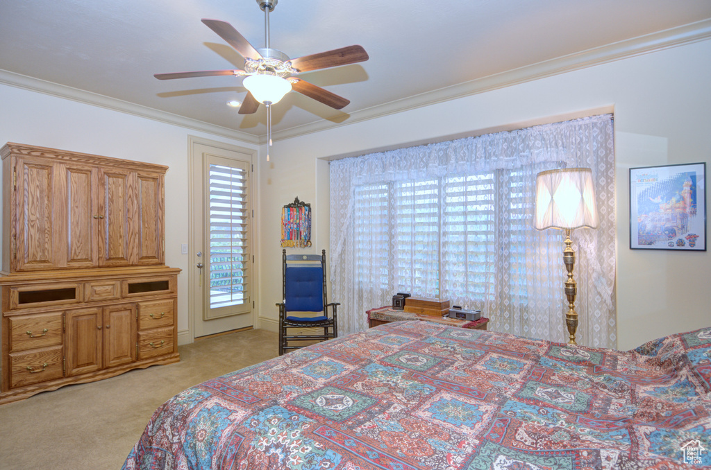 Carpeted bedroom featuring access to exterior, ornamental molding, and ceiling fan