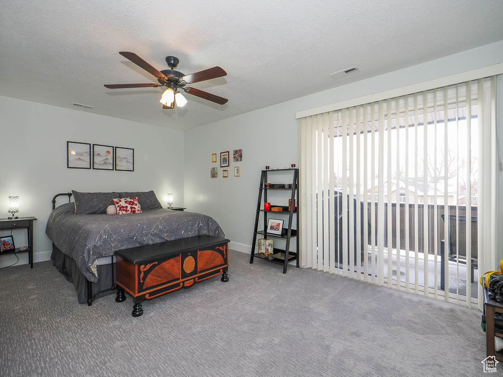 Bedroom featuring light colored carpet, access to exterior, a textured ceiling, and ceiling fan