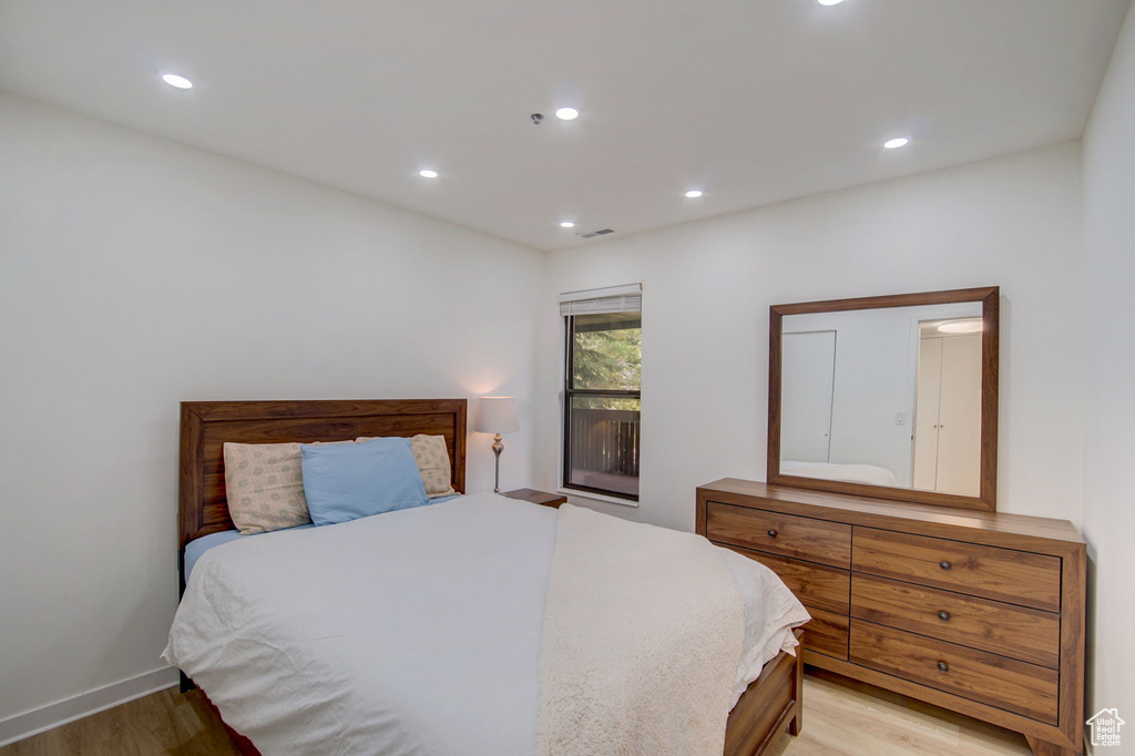 Bedroom with light hardwood / wood-style floors