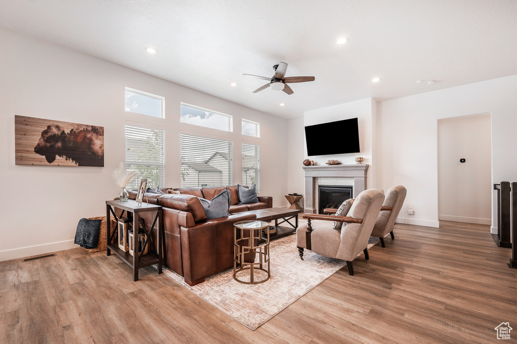 Living room featuring light hardwood / wood-style floors and ceiling fan
