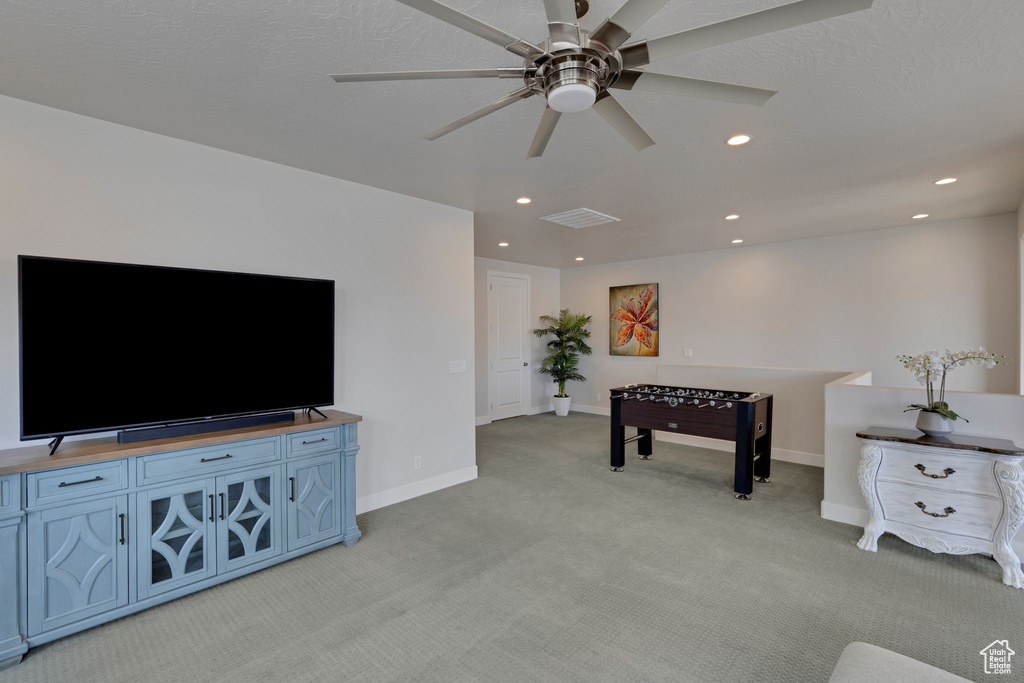 Living room with light colored carpet and ceiling fan
