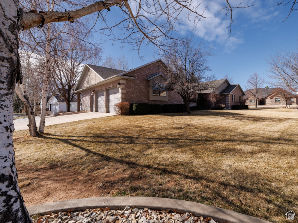 View of property exterior with a yard