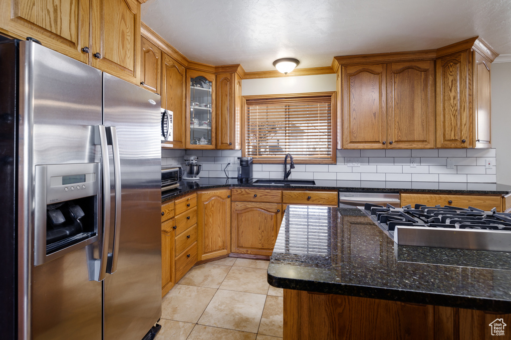 Kitchen featuring appliances with stainless steel finishes, tasteful backsplash, sink, and plenty of natural light
