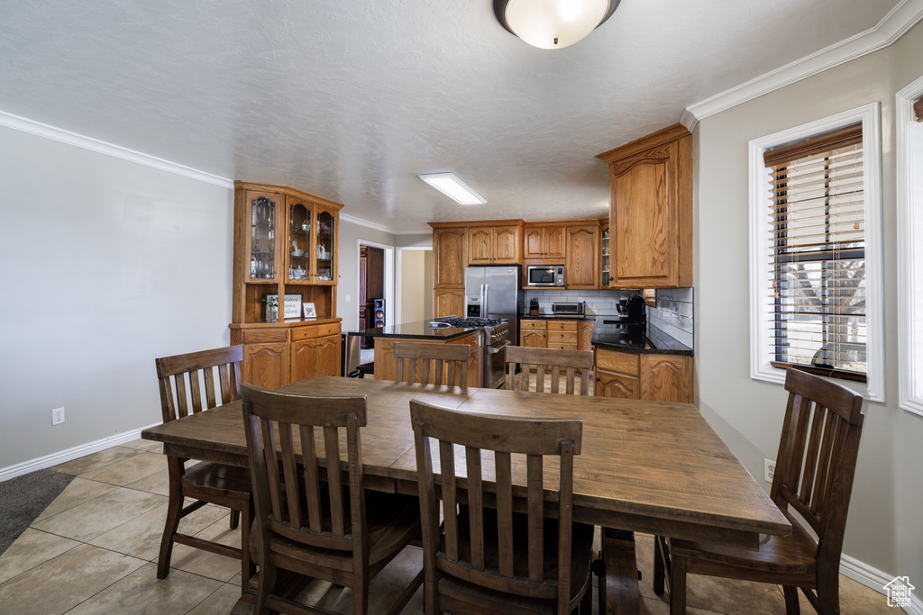 Tiled dining room with crown molding