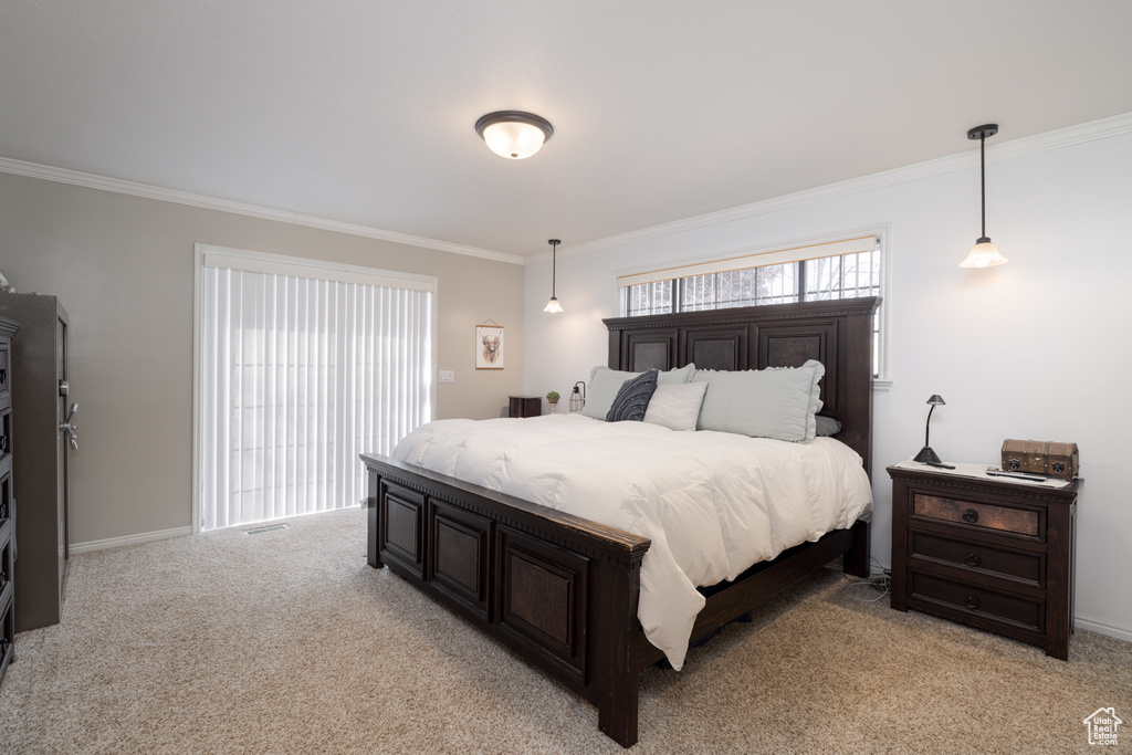 Bedroom featuring crown molding and light carpet