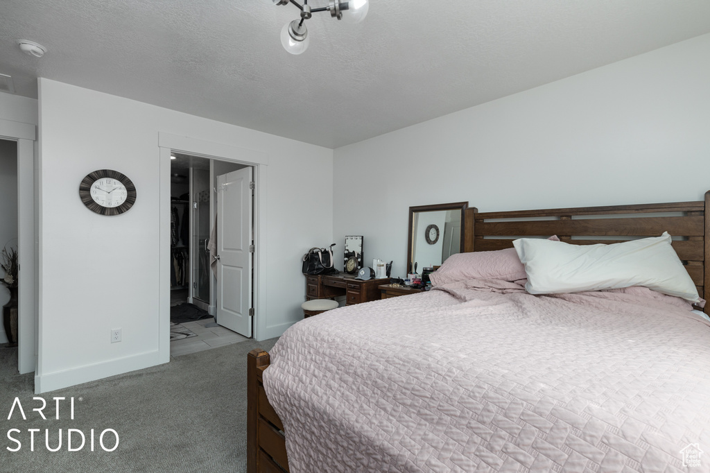 Bedroom featuring light colored carpet and ensuite bath