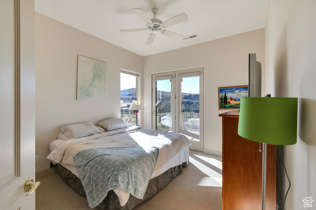 Bedroom featuring access to outside, ceiling fan, and light carpet