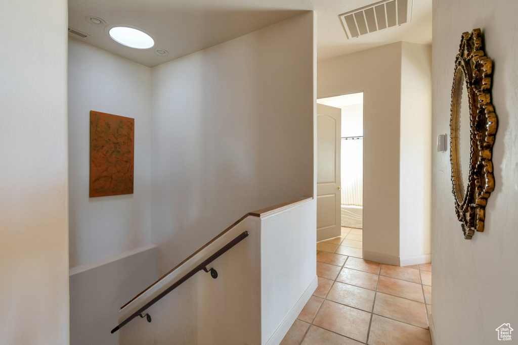 Hallway with light tile flooring