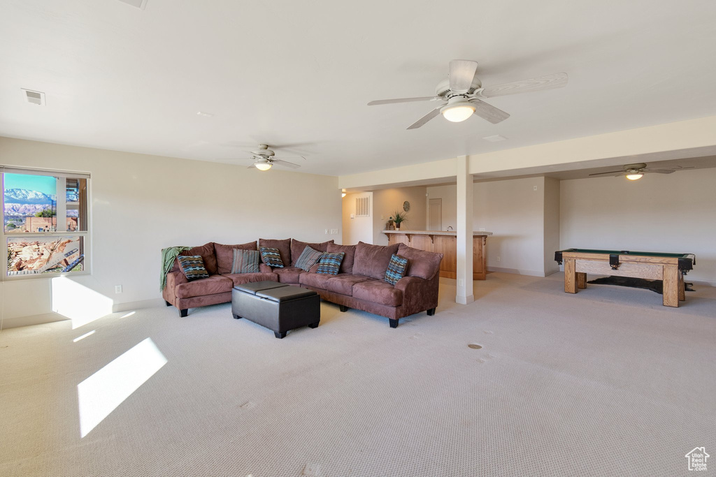 Carpeted living room featuring billiards and ceiling fan