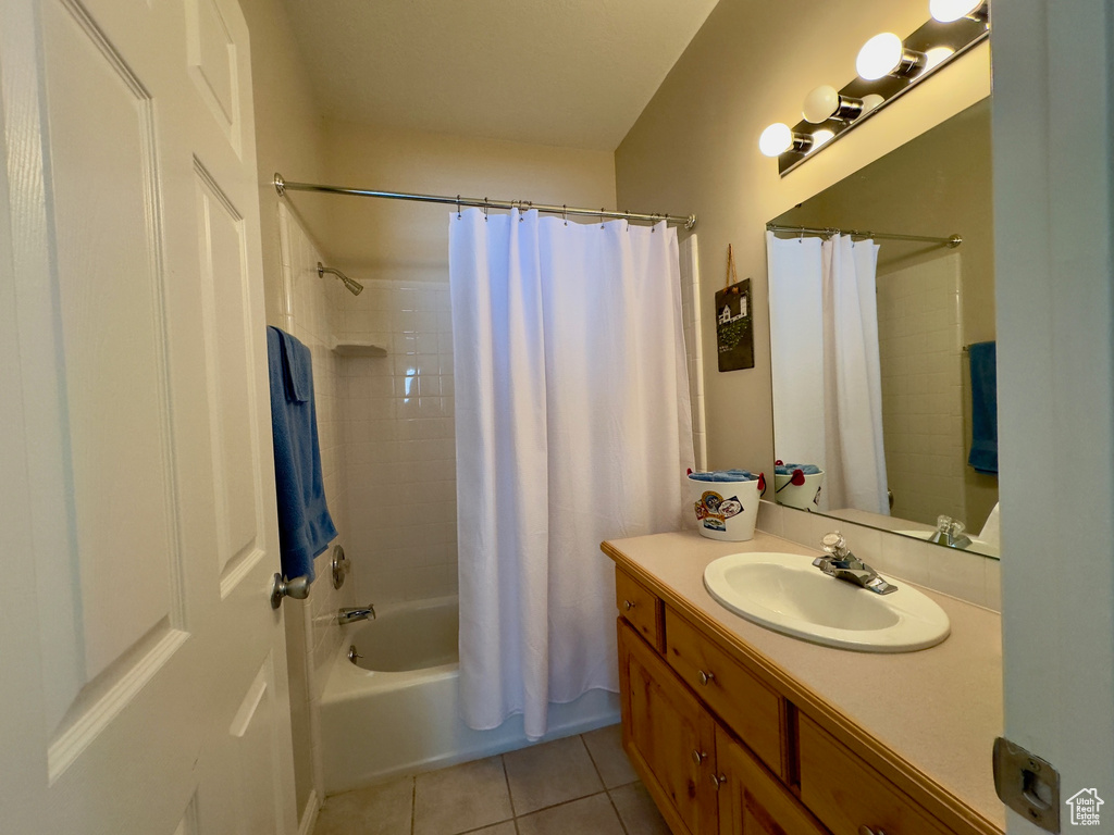 Bathroom featuring tile floors, vanity, and shower / bath combo