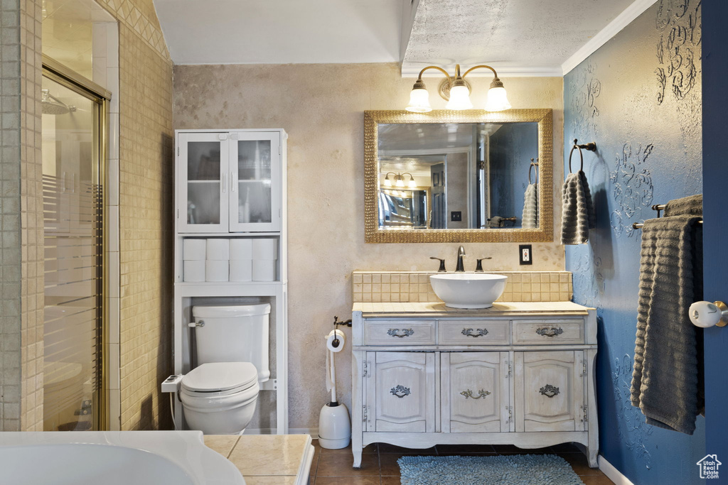 Bathroom with crown molding, a textured ceiling, toilet, and vanity