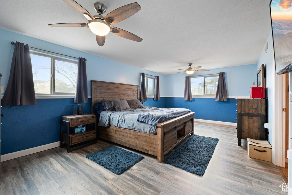 Bedroom with hardwood / wood-style flooring and ceiling fan